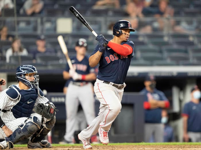 Jun 5, 2021; Bronx, New York, USA; Boston Red Sox third baseman Rafael Devers (11) hits an RBI single during the sixth inning against the New York Yankees at Yankee Stadium.